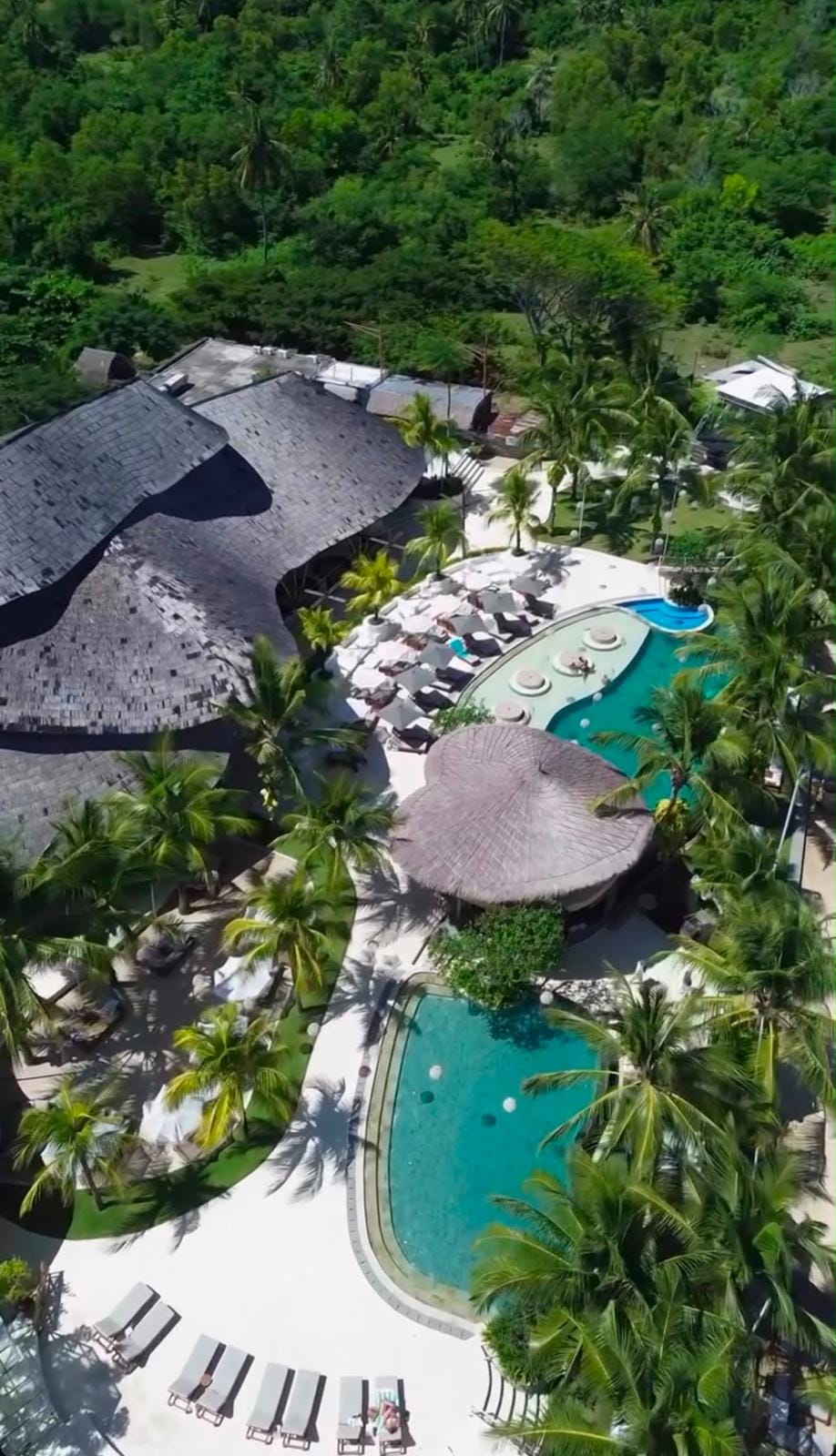 Aerial view of the club against the green hillside