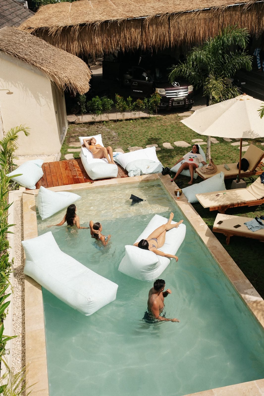 Guests relaxing in and around the pool